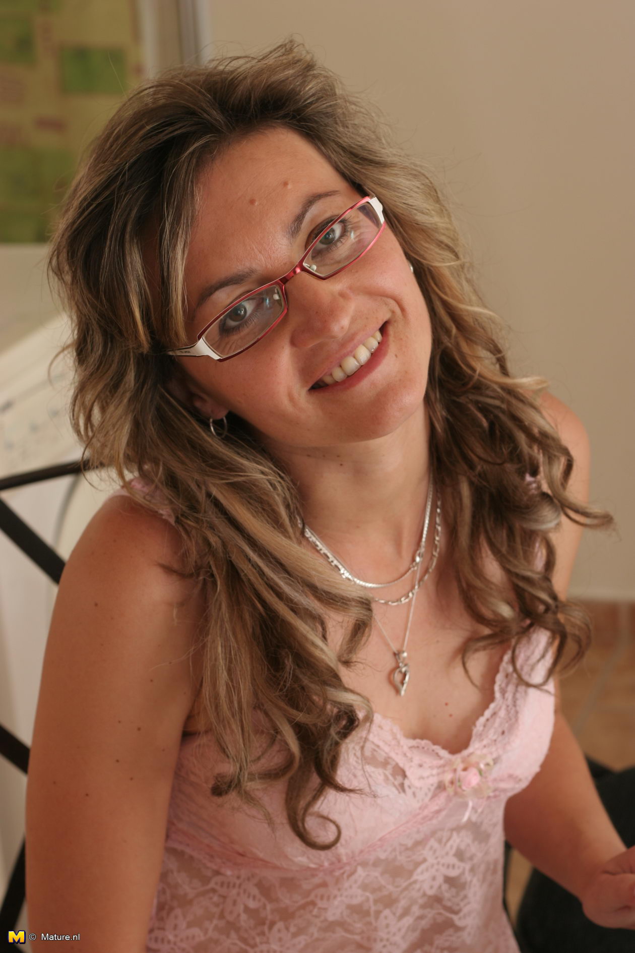 Mature in glasses appart her legs and shows pussy photo image picture